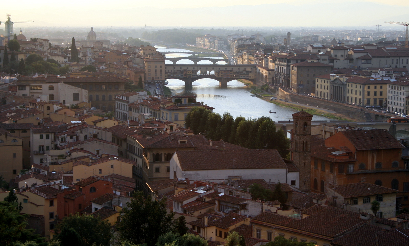 Ponte Vecchio at golden hour from the Oltrarno side — the view that ends Day 3