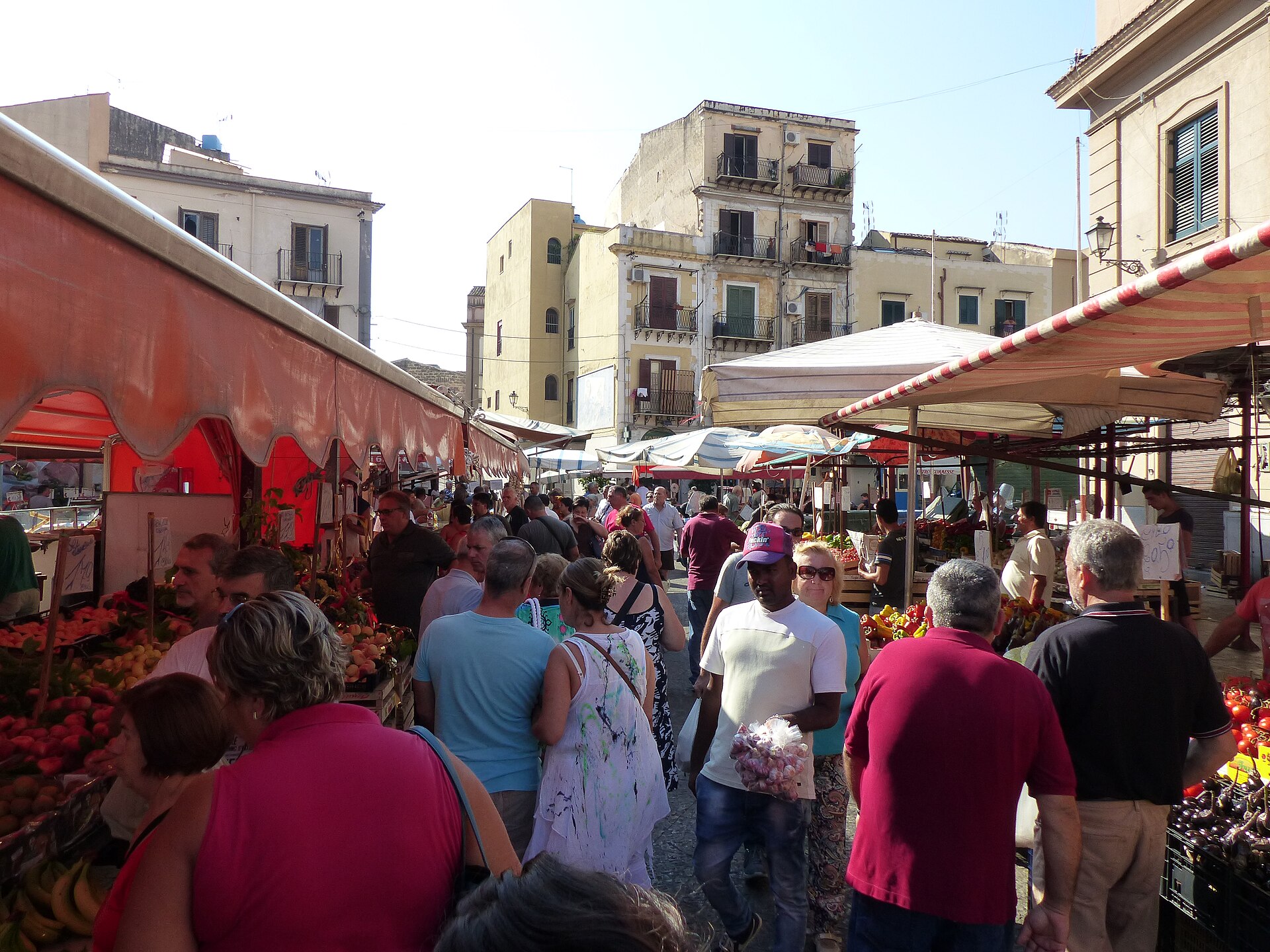 Vendors and shoppers at Palermo's Ballarò market, showing why Sicily ranks among the most affordable places in Italy