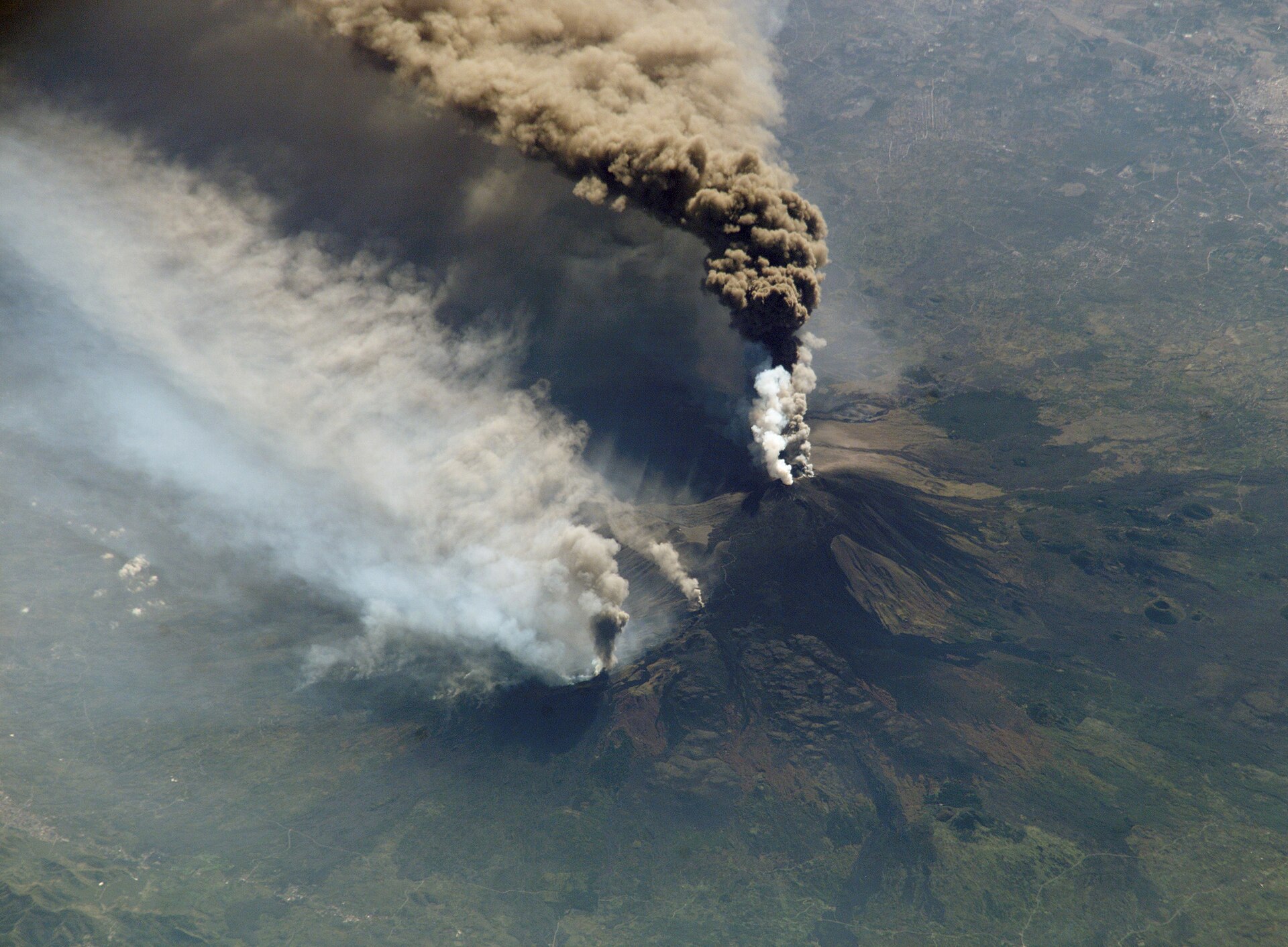 Steaming summit craters of Mount Etna seen from the high 4x4 tour zone above the Funivia cable car station