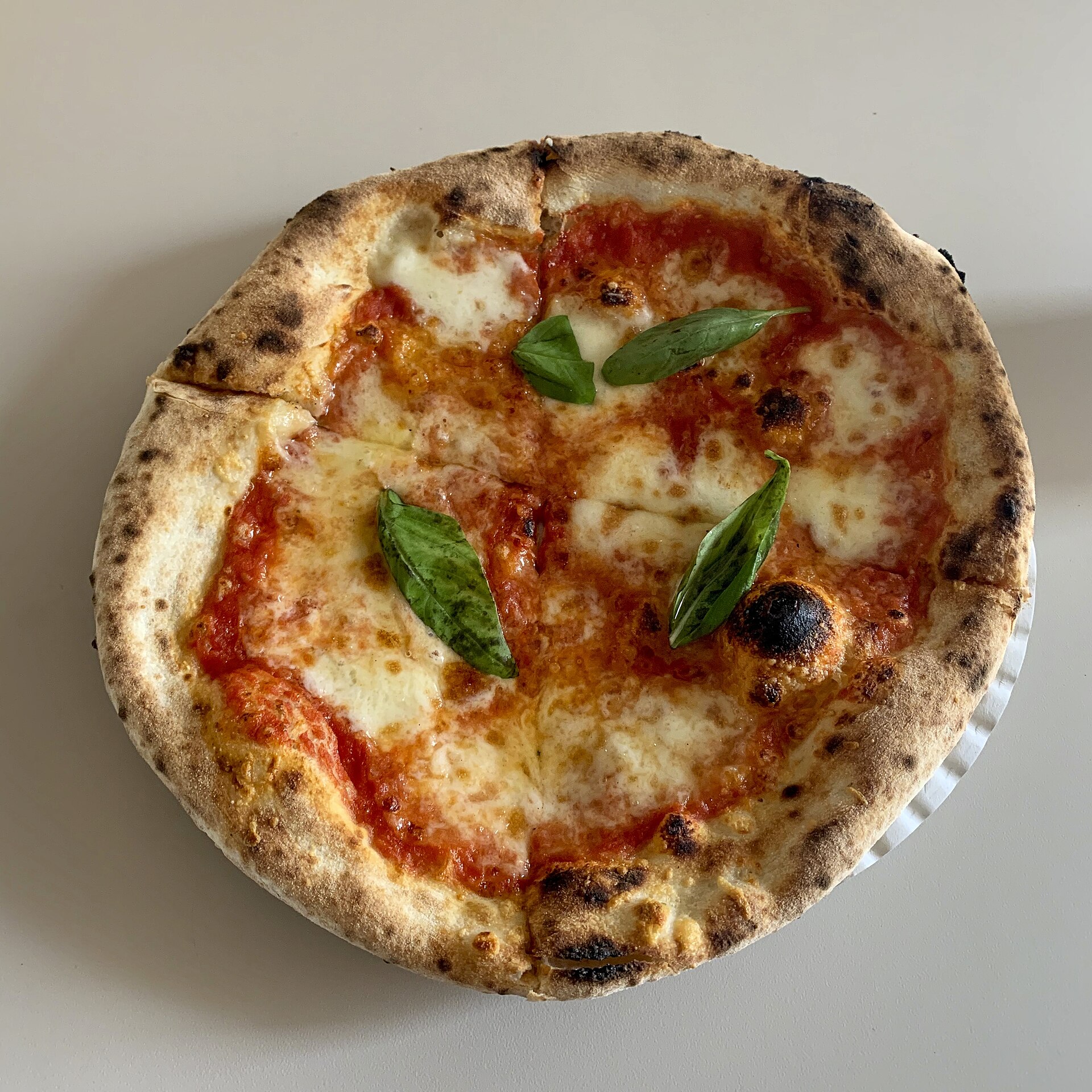 A classic Neapolitan margherita pizza, one of the best-value items in the cost of food in Italy