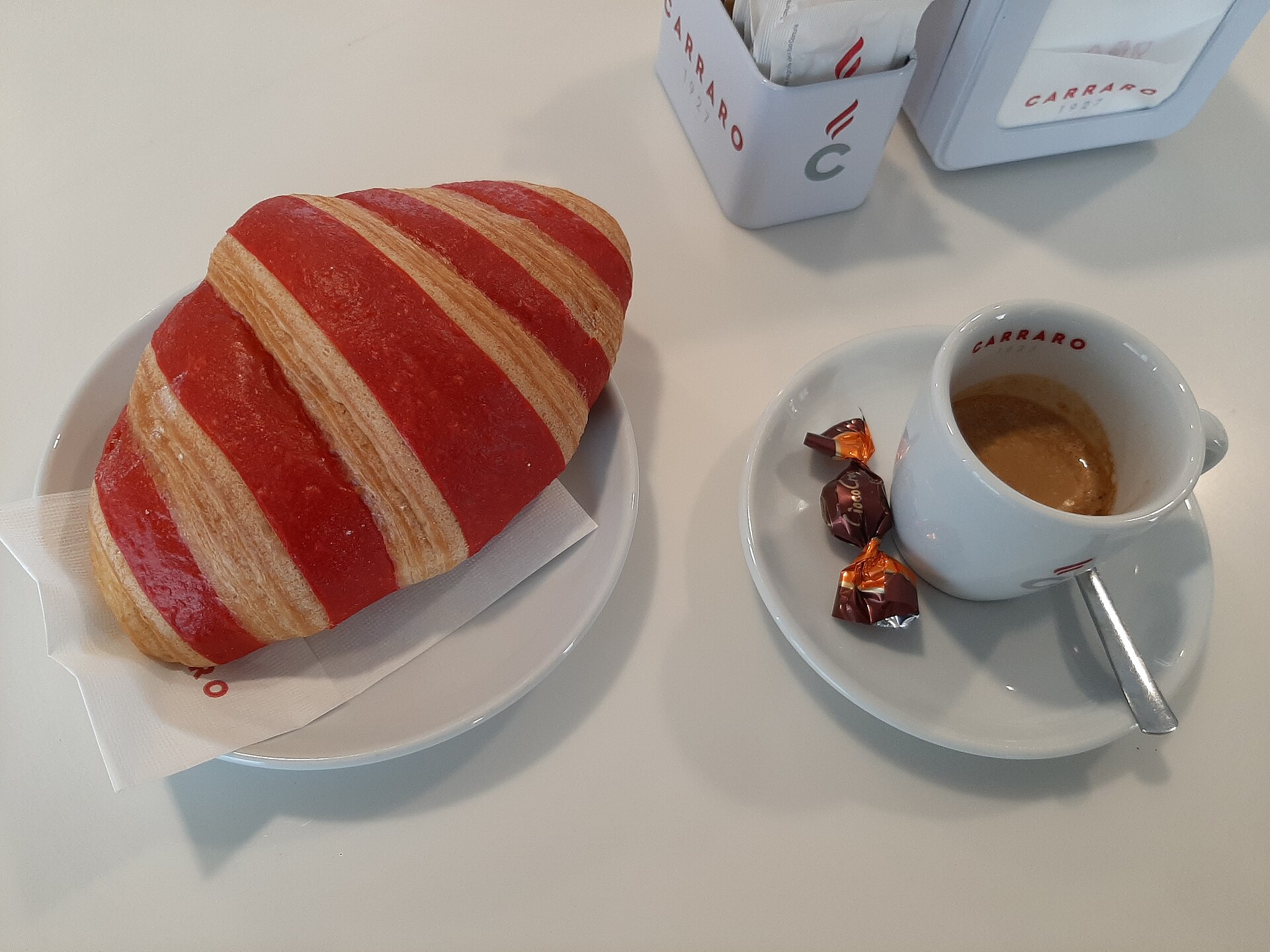 A cornetto pastry, the standard Italian breakfast pairing for morning coffee