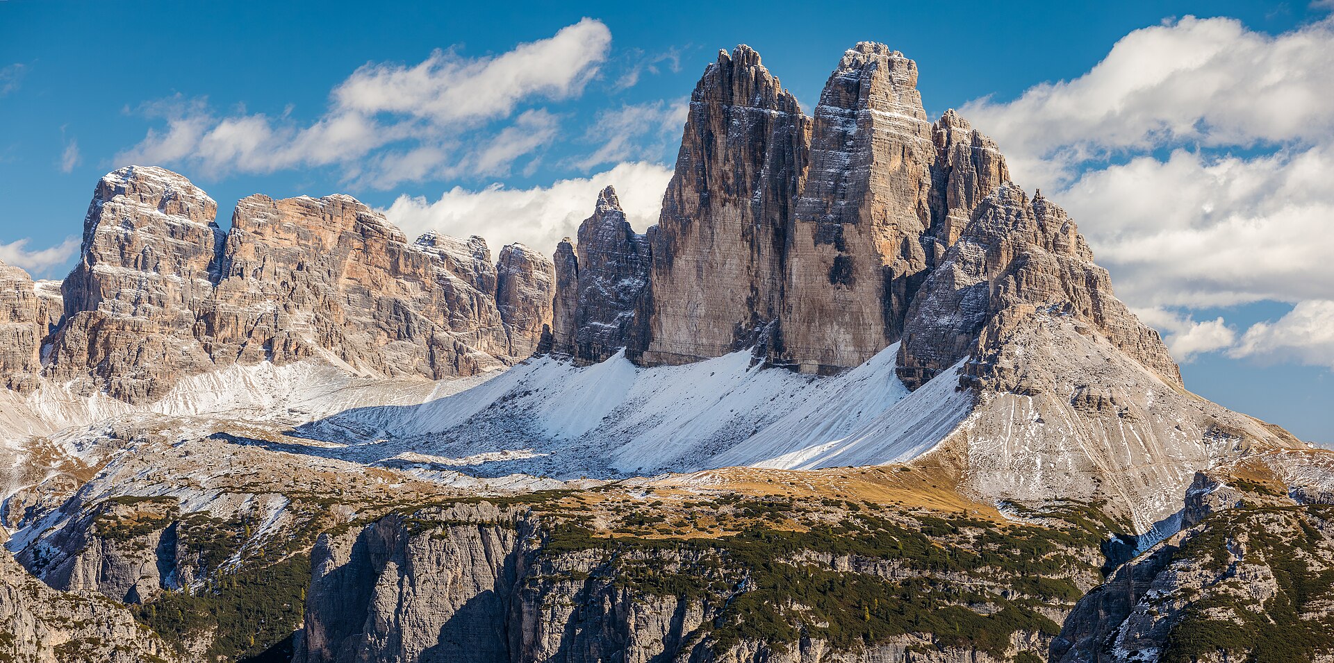 The Dolomites in June: alpine wildflowers frame the famous Tre Cime peaks at the start of the hiking season