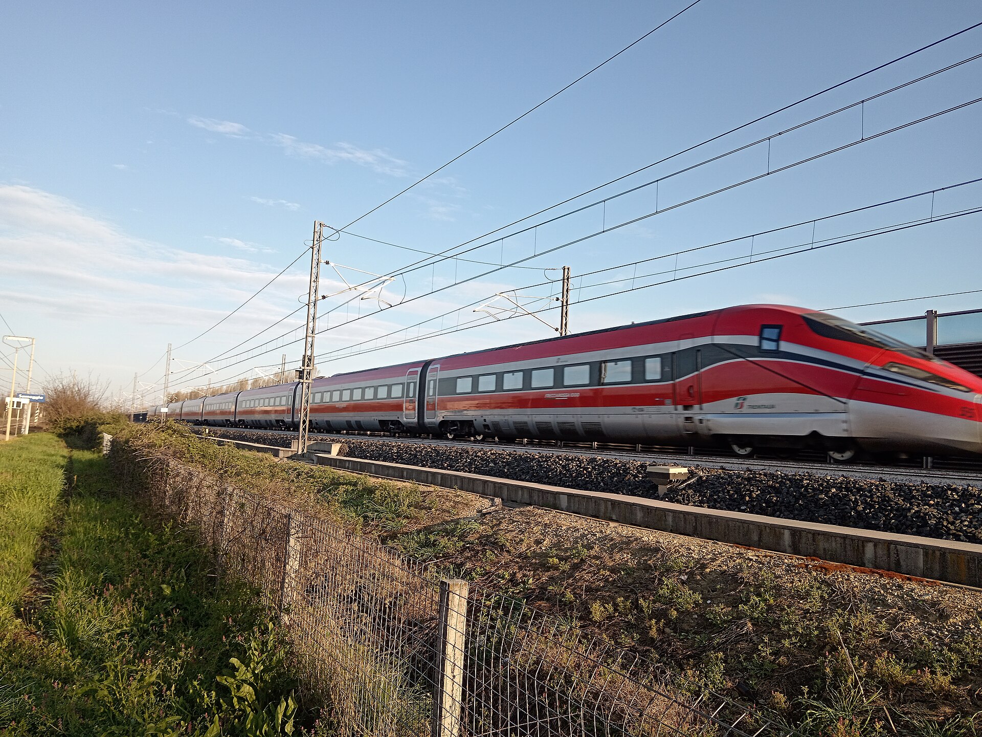 Travelers waiting inside an Italian train station