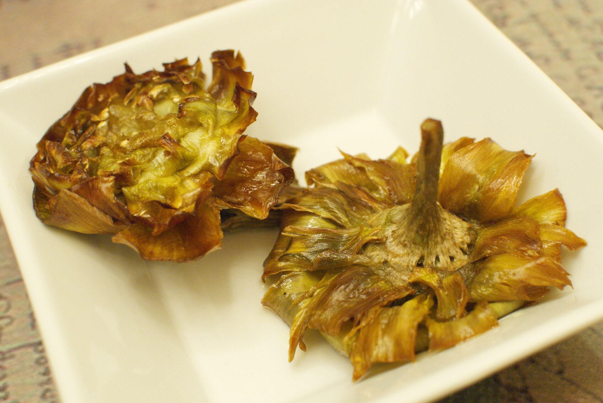 A golden, deep-fried carciofi alla giudia in the Jewish Ghetto, a signature of Rome food