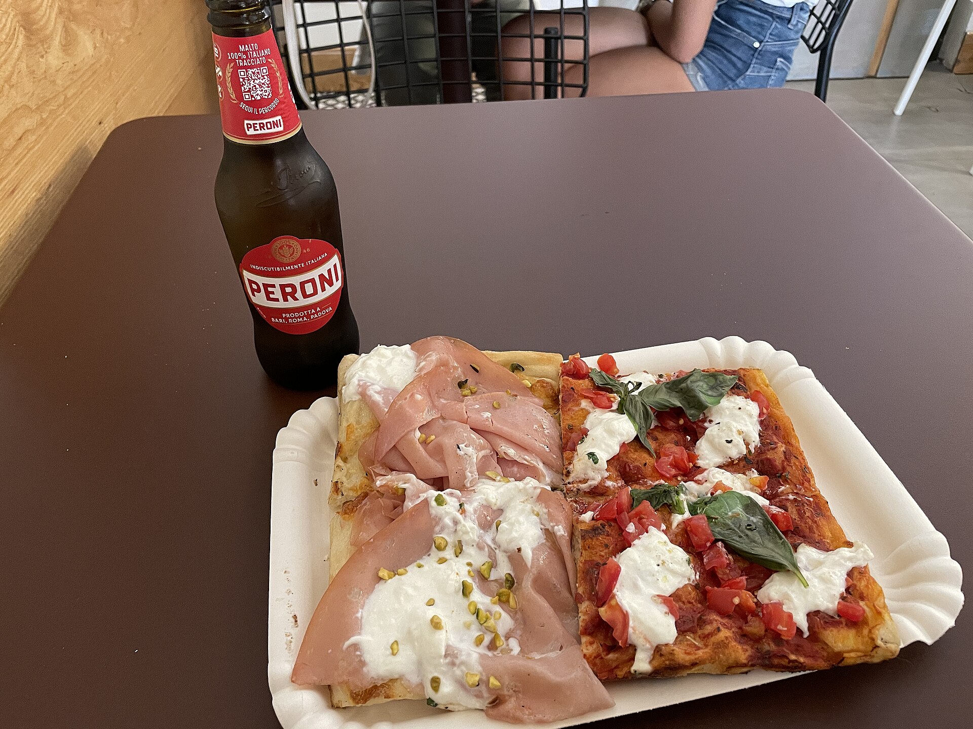 Pizza al taglio in a Rome bakery — sold by weight, eaten standing up