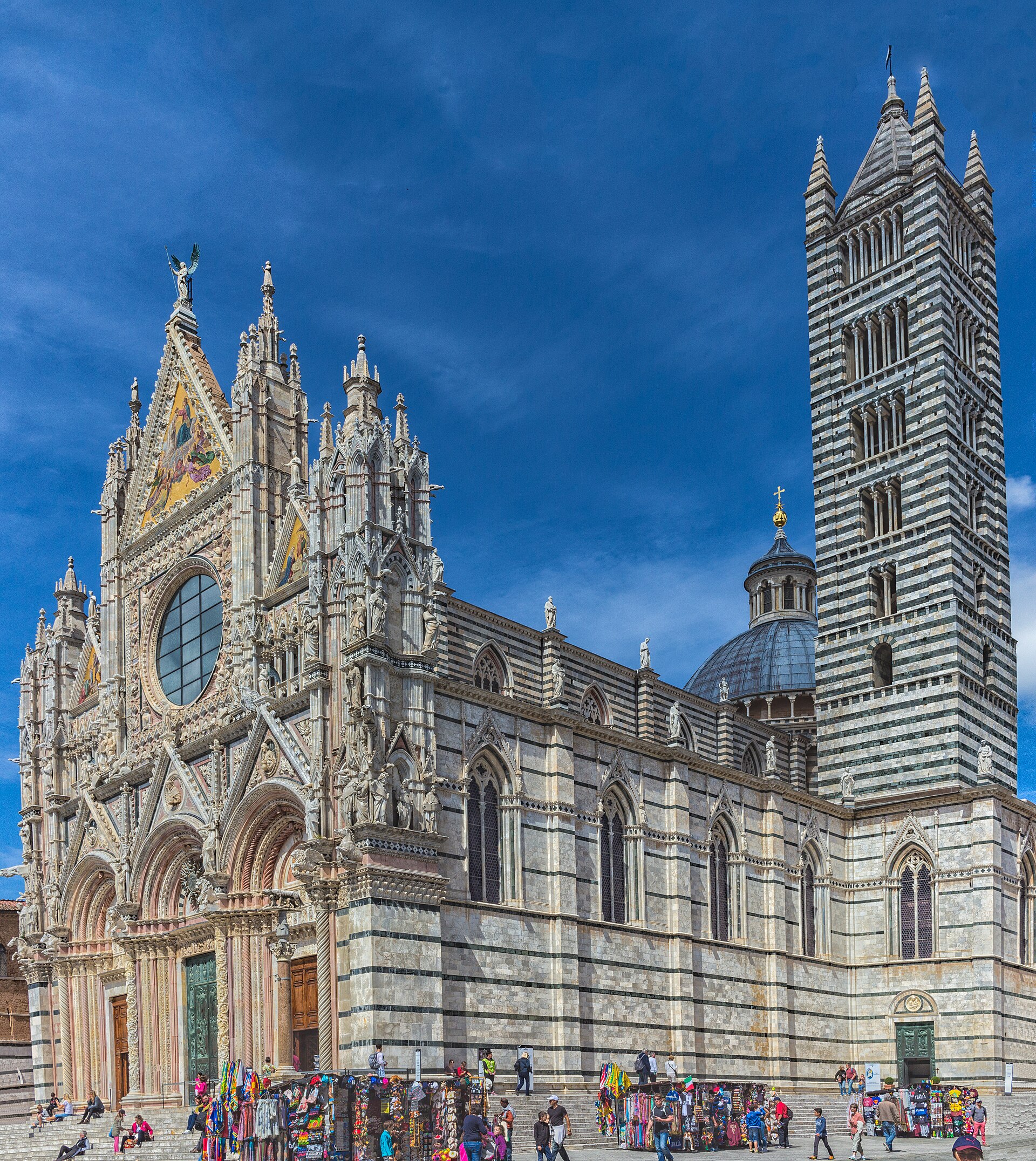 The Siena Cathedral facade — black-and-white marble stripes, Gothic pinnacles, and Pisano sculptures that have survived seven centuries