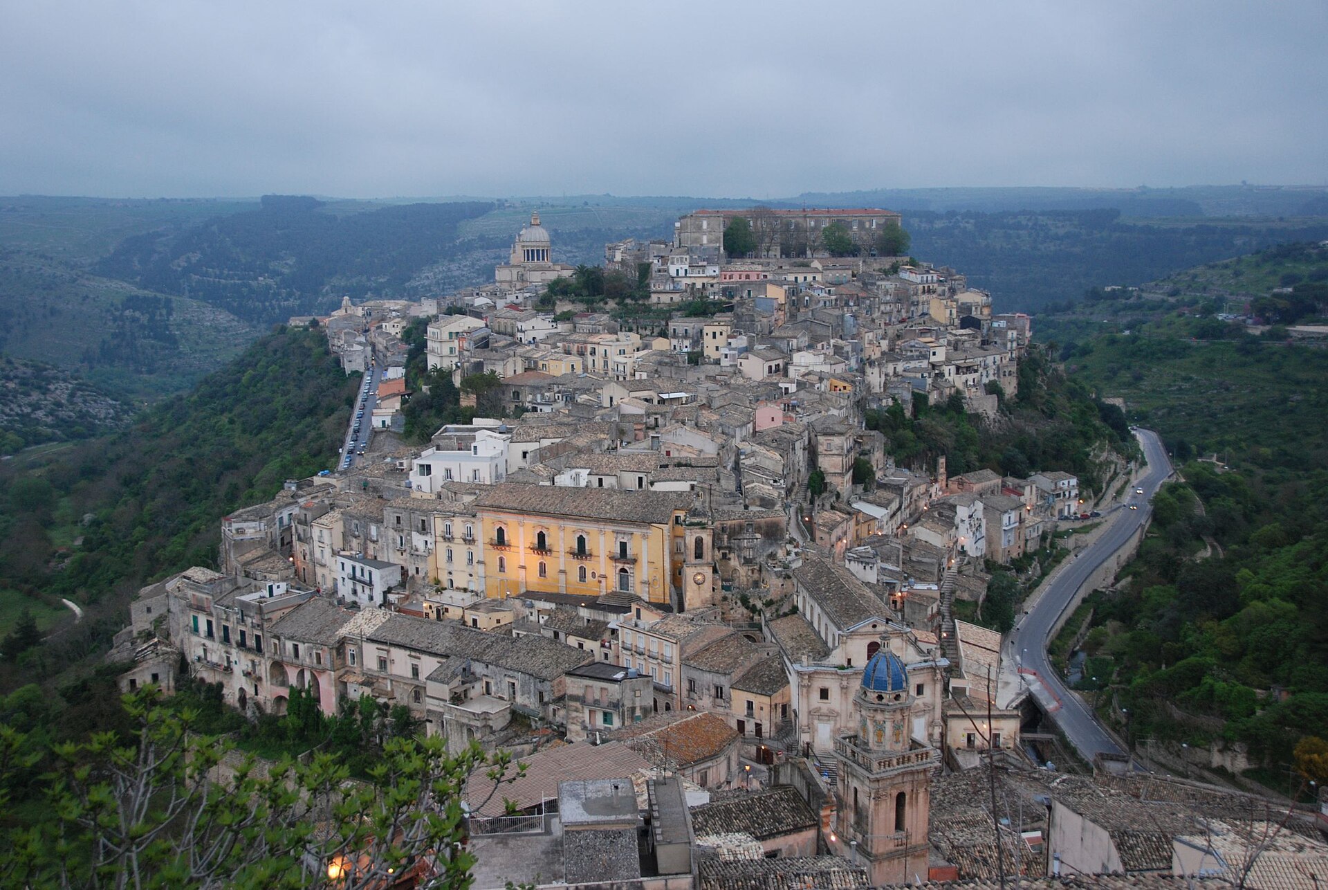 The domed cathedral and tumbling rooftops of Ragusa Ibla in Sicily's Baroque southeast at golden hour