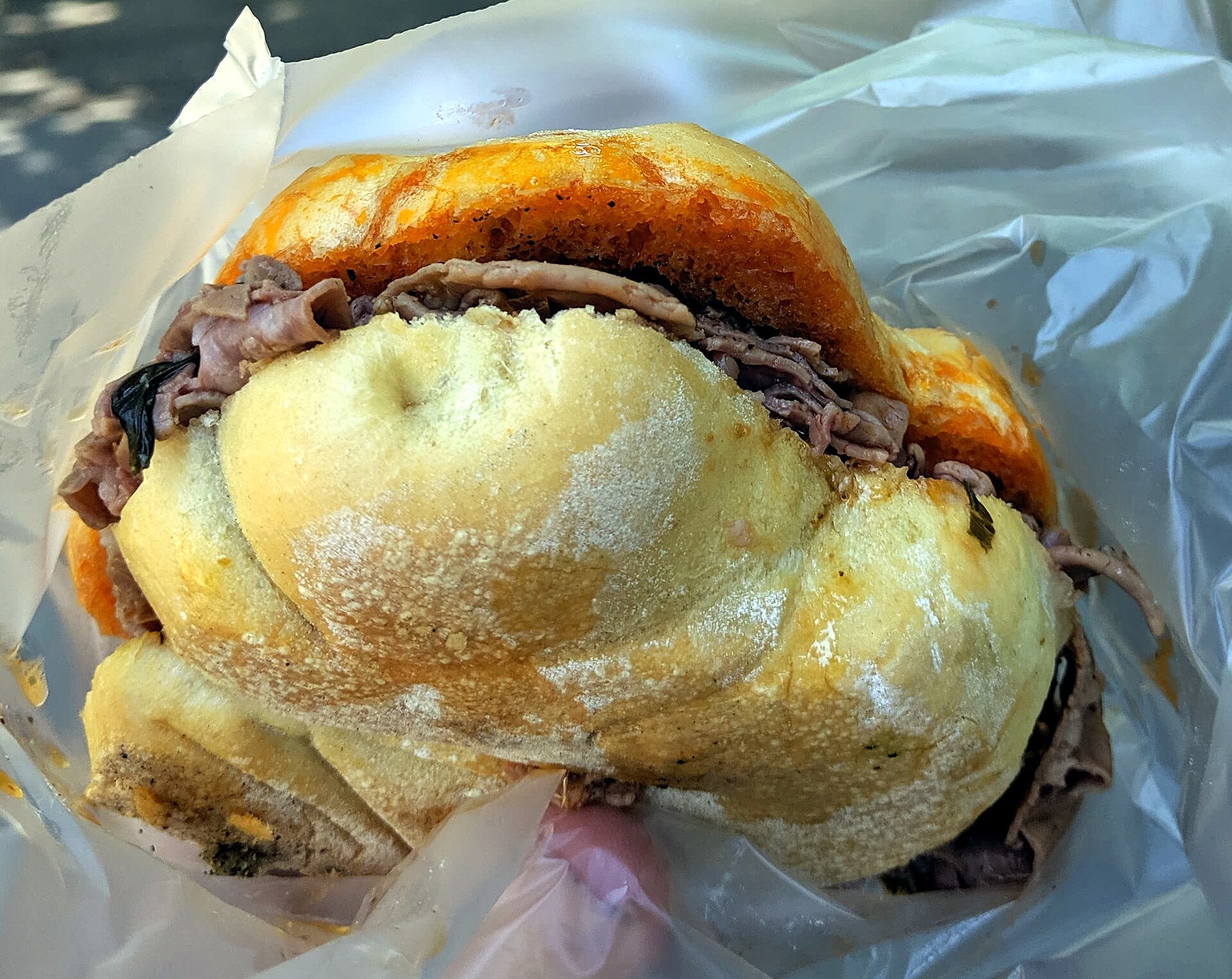 A lampredotto panino from a Florence street cart, the city's iconic cucina povera street food