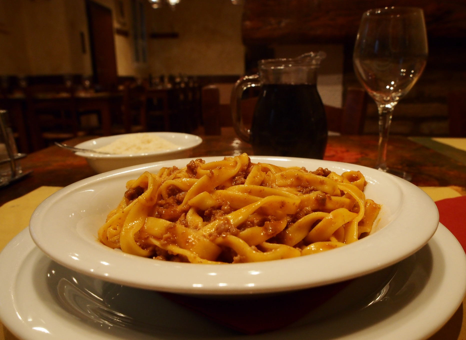 A plate of fresh tagliatelle al ragù, one of the best answers to what to eat in Italy, served in Emilia-Romagna